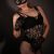 Bağcılar Escort Bayan Yabancı Sera Yeni Bayan Woman in black lace lingerie, fishnet stockings, gloves, and a cat mask posing against a dark backdrop.